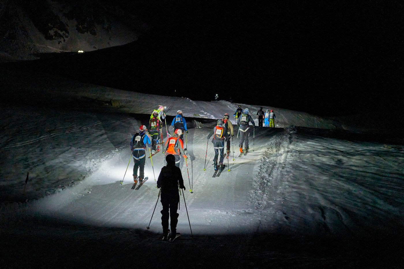 A climber's headlamp on a night ascent at altitude.