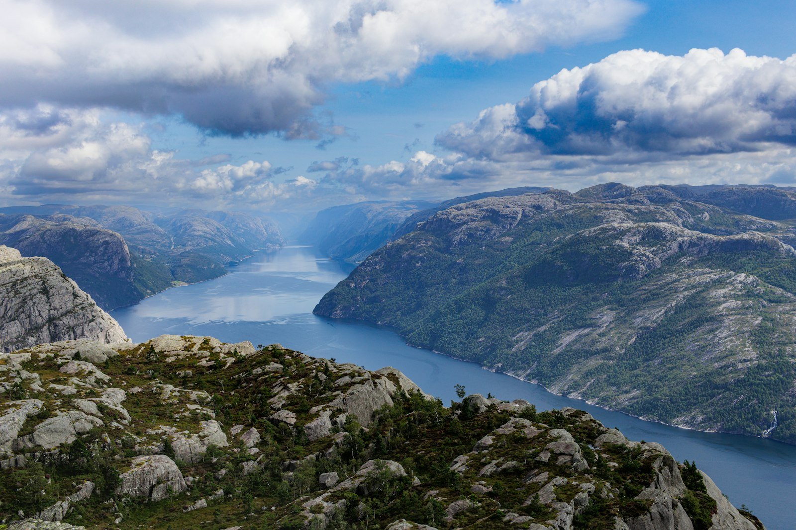 A wide Norwegian fjord landscape with hiking trail.