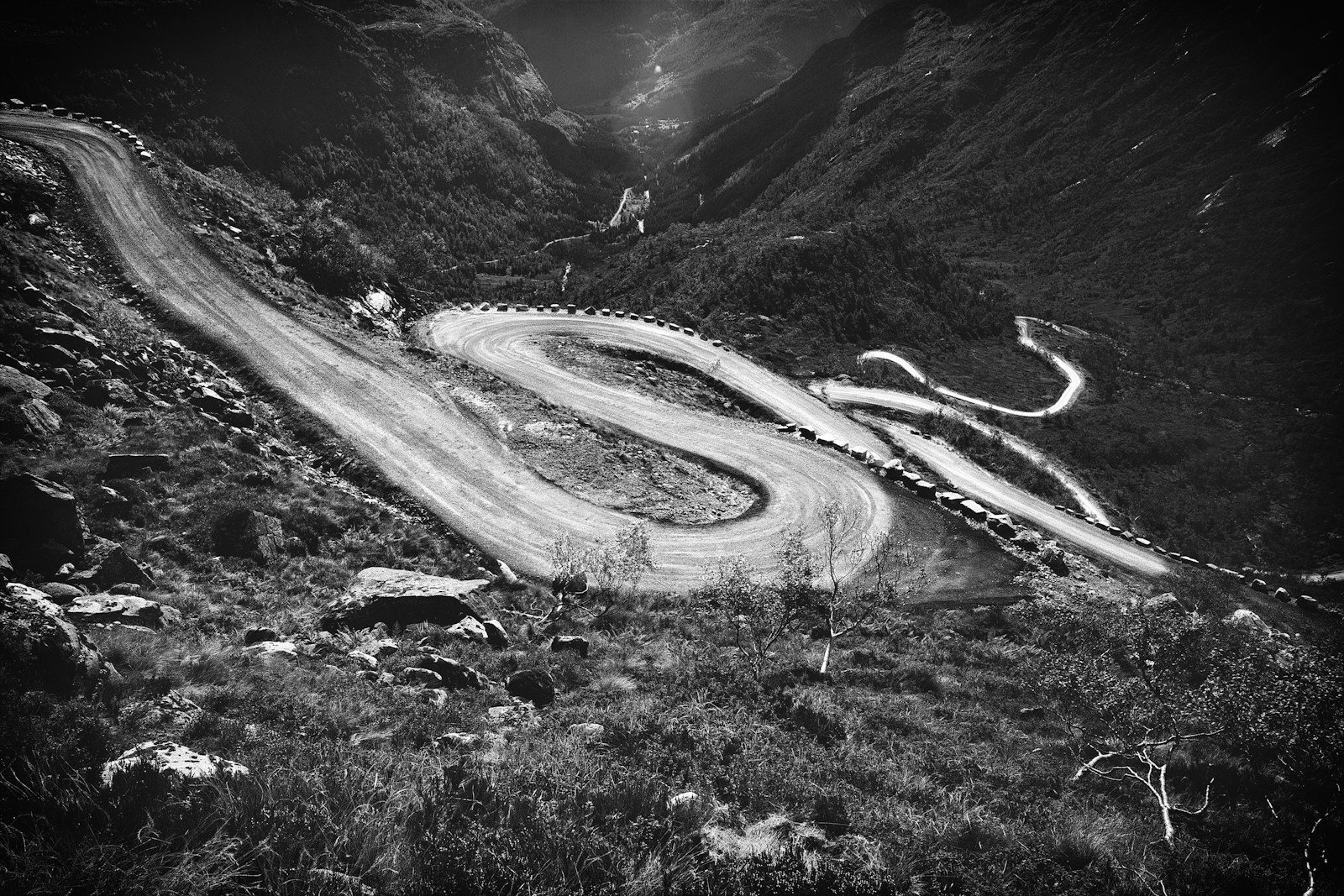 Winding mountain road cuts through the valley.